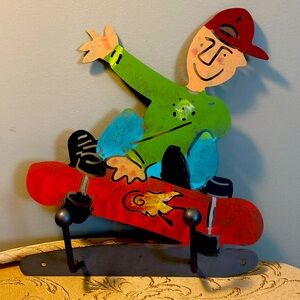 Metal skateboarder that has hooks for hanging